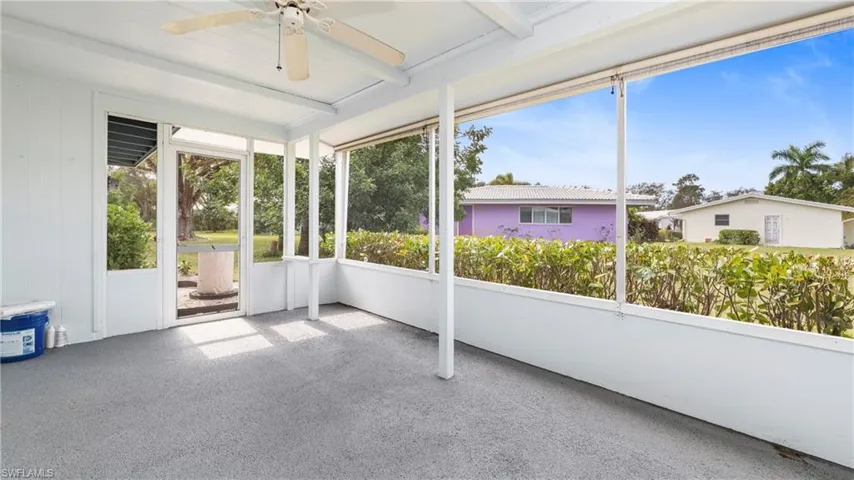 Unfurnished sunroom featuring ceiling fan