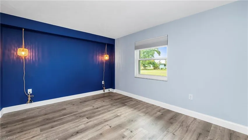 Empty room featuring light wood-type flooring and baseboards