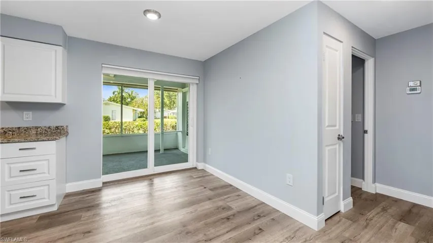 Unfurnished dining area with baseboards and light wood-style flooring