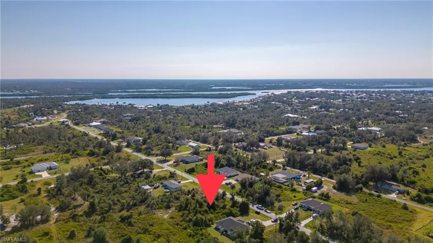 Aerial overview of property's location with a nearby body of water