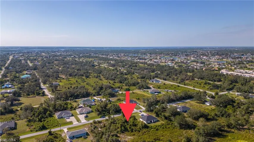 Aerial view of property and surrounding area with nearby suburban area