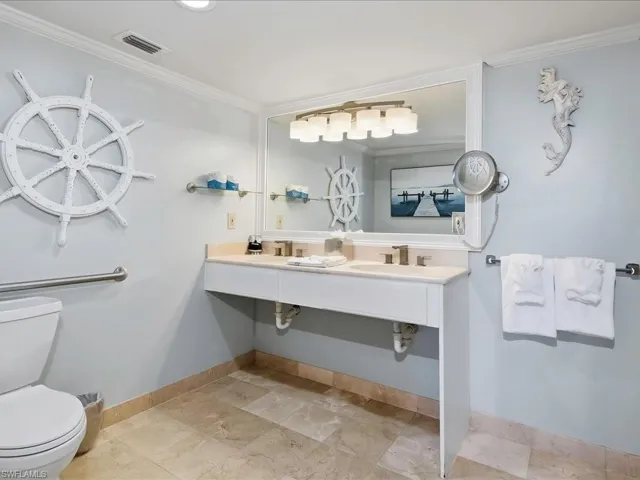Spa-inspired bathroom featuring a floating vanity with dual sinks, quartz countertop, and contemporary lighting