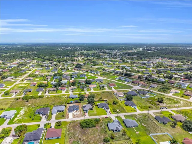 Expansive residential neighborhood featuring numerous single-story homes, established street grid, and undeveloped land parcels