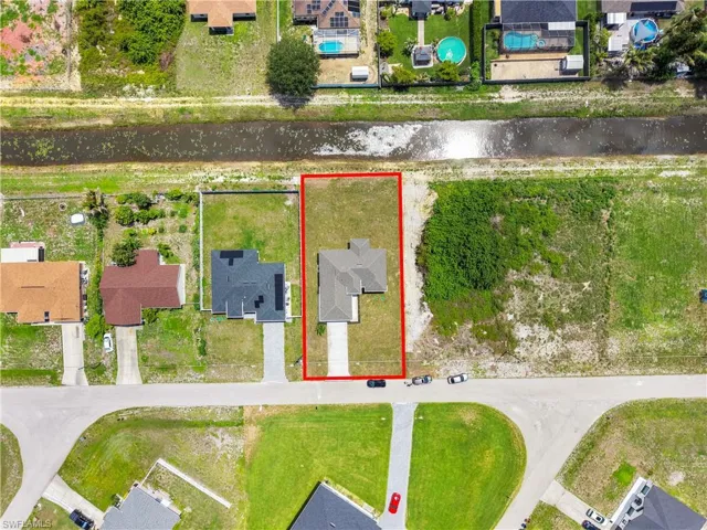 Aerial perspective showcasing a residential property with a defined lot boundary