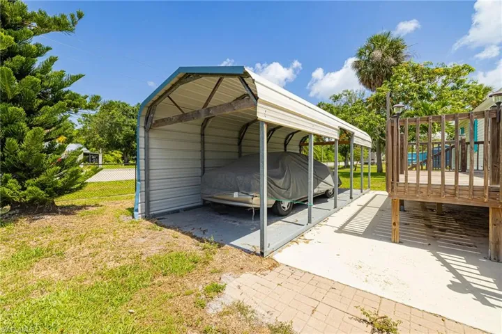 View of parking with a detached carport