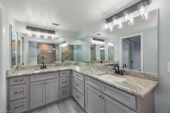 Bathroom with double vanity and a tile shower