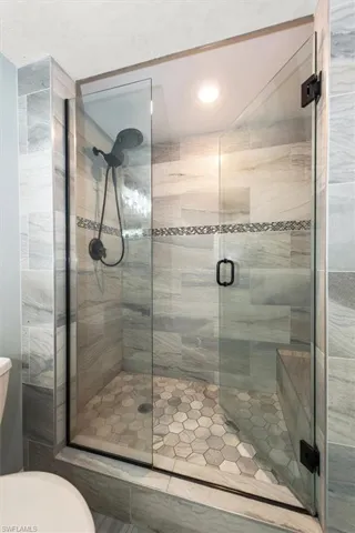 Full bathroom with a shower stall and recessed lighting