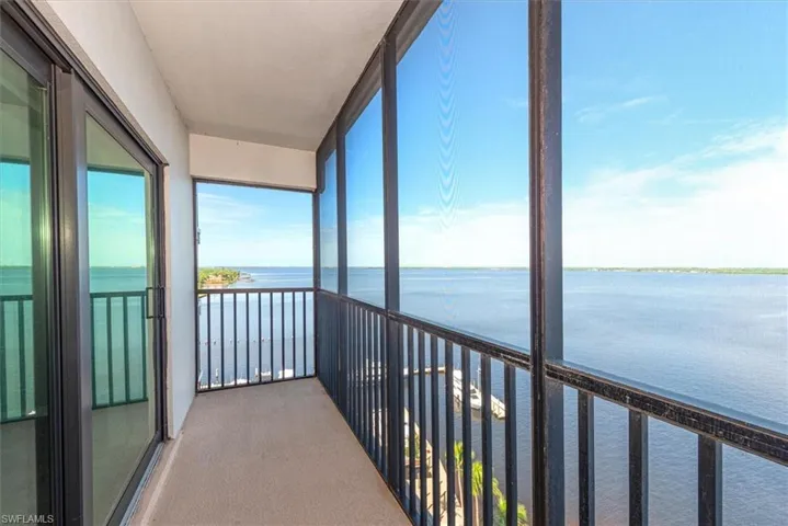 Unfurnished sunroom with a water view