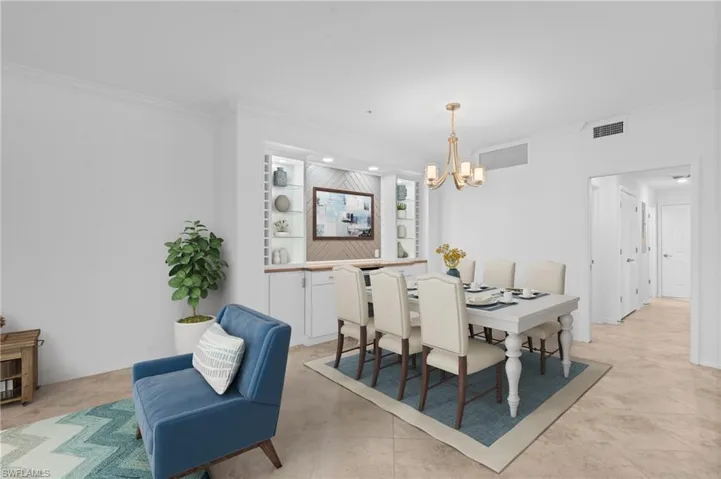 Dining area featuring ornamental molding, a chandelier, and recessed lighting