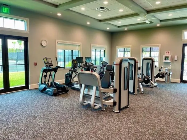 Workout area with a high ceiling, recessed lighting, baseboards, and visible vents