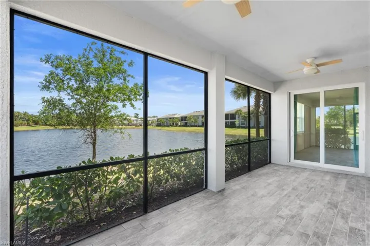 Unfurnished sunroom with a water view and wood finished floors