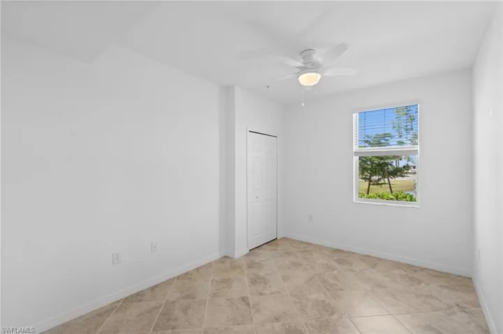Empty room featuring baseboards and ceiling fan