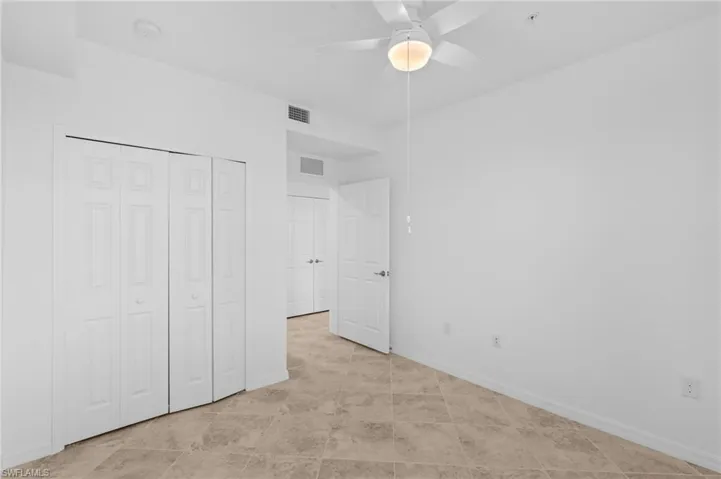 Unfurnished bedroom featuring baseboards, a closet, ceiling fan, and visible vents
