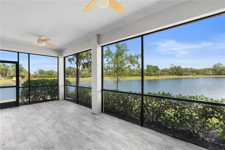 Unfurnished sunroom with wood finished floors and a water view
