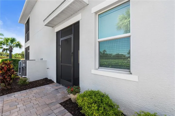 Doorway to property with stucco siding