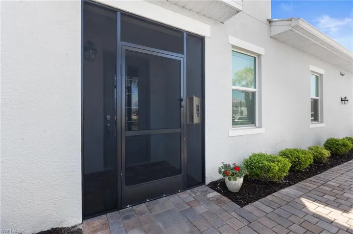 Doorway to property featuring stucco siding