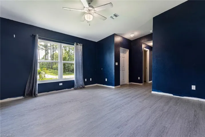 Unfurnished room with ceiling fan and hardwood / wood-style floors