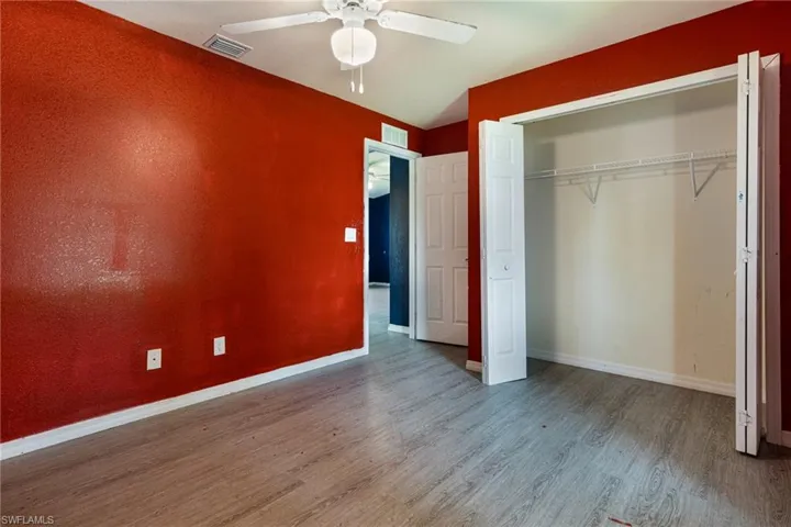 Unfurnished bedroom featuring ceiling fan, wood-type flooring, and a closet