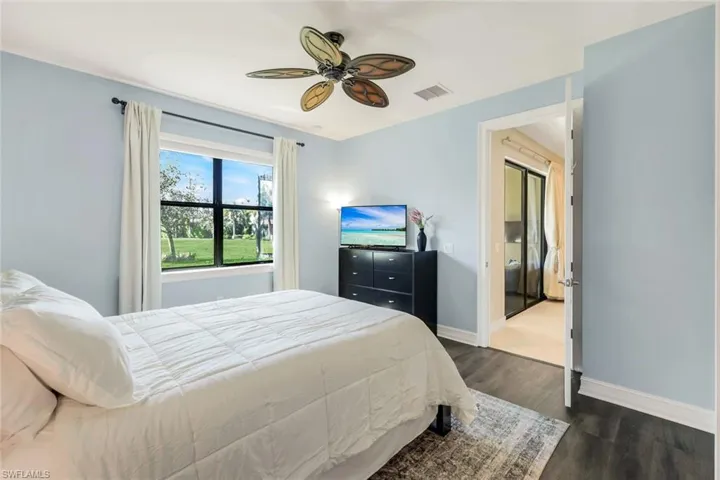 Bedroom with dark wood-type flooring and ceiling fan