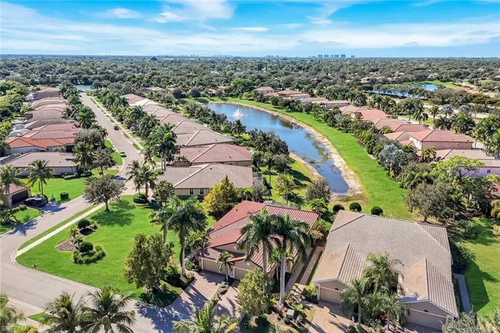 Aerial perspective of suburban area featuring a nearby body of water