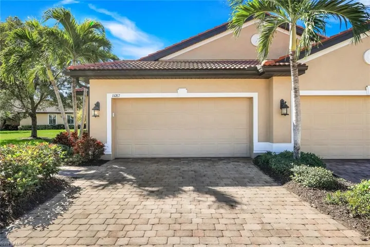 Garage featuring decorative driveway