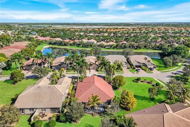 Aerial perspective of suburban area featuring a nearby body of water