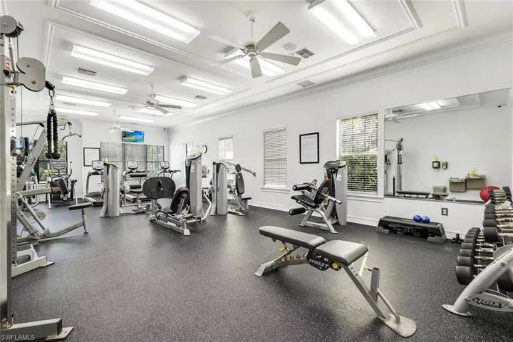 Exercise room with ceiling fan and crown molding
