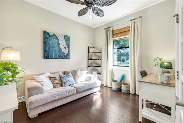 Living room with hardwood / wood-style floors and a ceiling fan