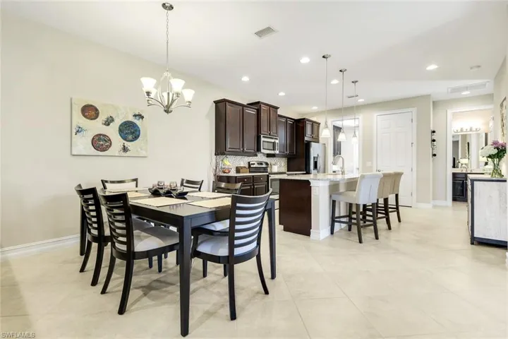Dining room with a chandelier and recessed lighting