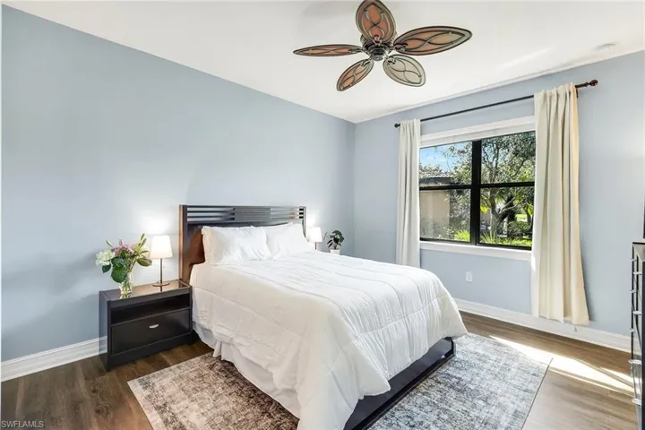 Bedroom featuring ceiling fan and dark wood-style floors