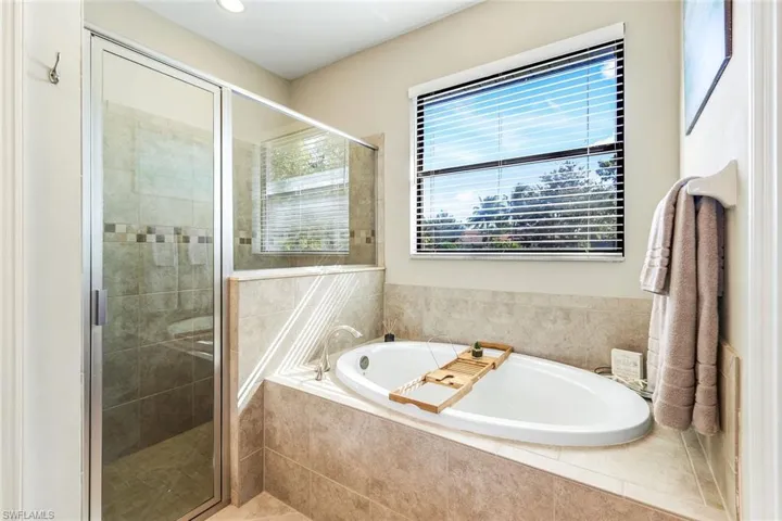 Bathroom with a bath and a shower stall