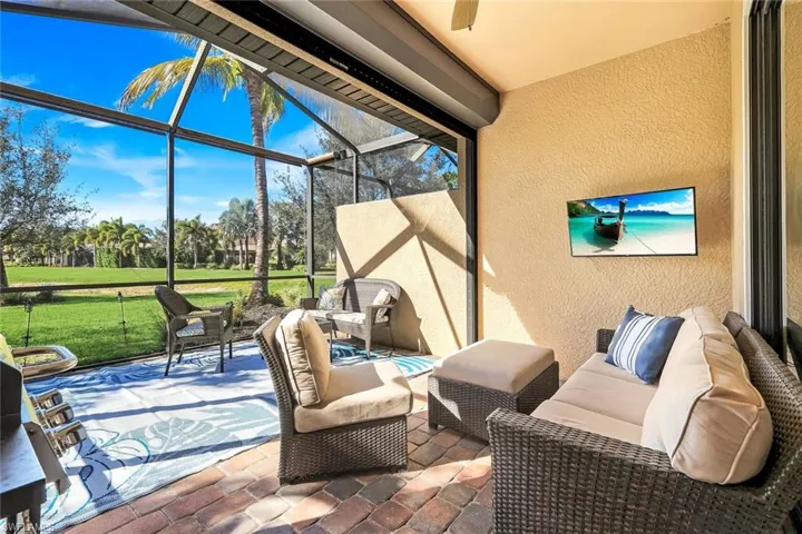 View of patio with a sunroom, glass enclosure, and outdoor lounge area