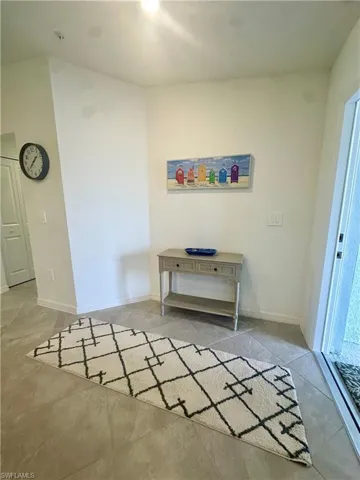 Tiled foyer entrance with baseboards