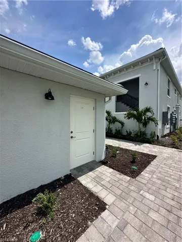 View of exterior entry with stucco siding