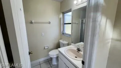 Full bath featuring vanity, light tile patterned flooring, and a shower with curtain