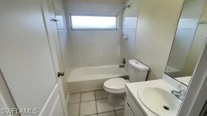 Full bath featuring vanity, shower / washtub combination, and light tile patterned flooring