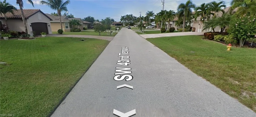 View of asphalt road featuring a residential view