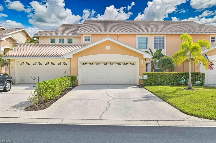View of front of home with driveway and stucco siding