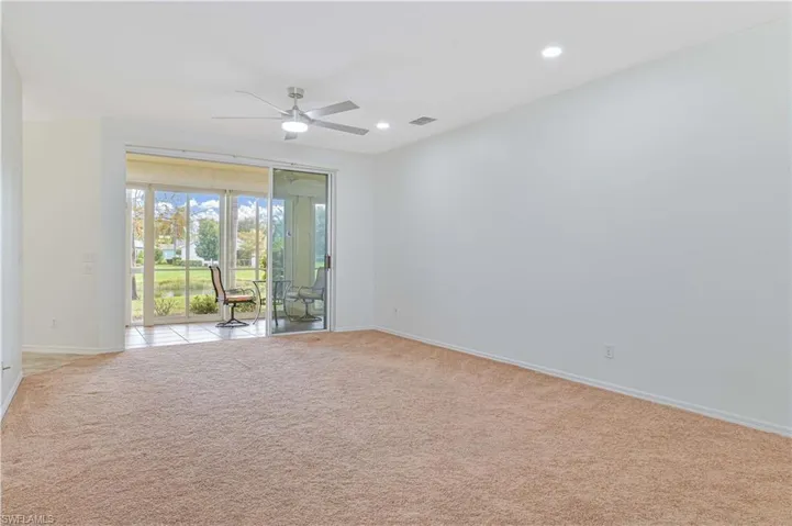 Empty room featuring light colored carpet, a ceiling fan, and recessed lighting