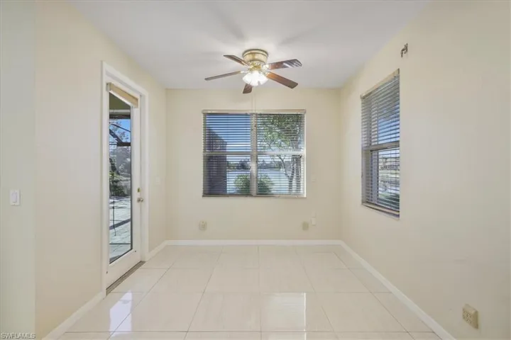 Spare room with ceiling fan and light tile patterned floors