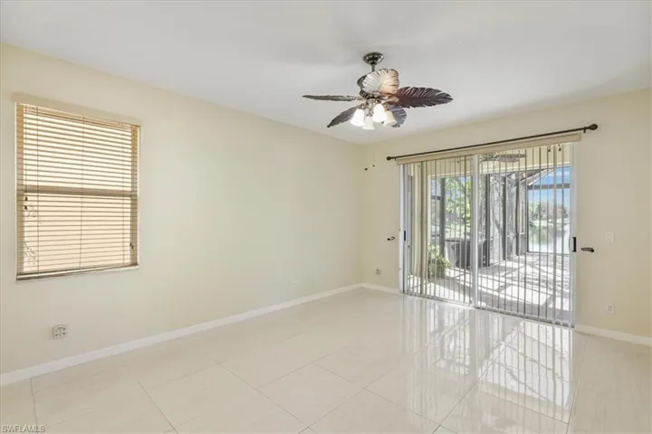 Unfurnished room with ceiling fan and light tile patterned flooring