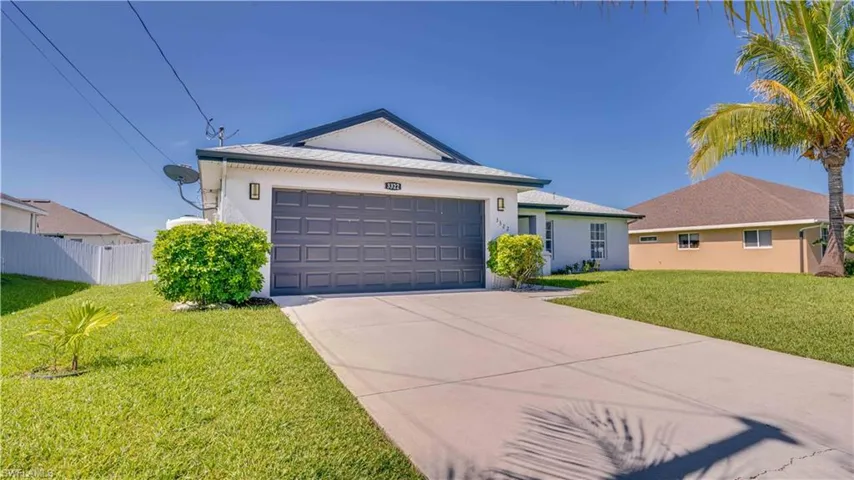 Single story home with stucco siding, concrete driveway, a garage, and a shingled roof