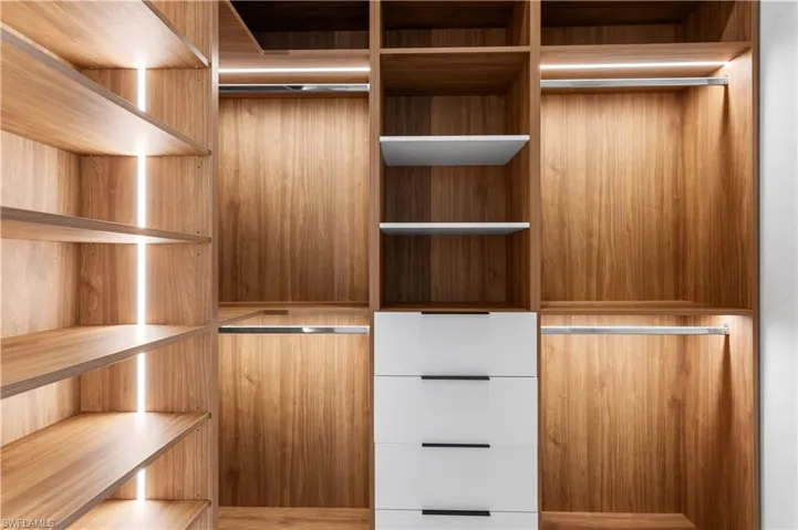 HIS-&-HER walk-in CLOSETS w/ custom WRAPAROUND LIGHTED CABINETRY