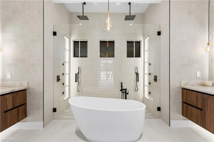 LUXURIOUS MASTER BATH w/ FULL GLASS WALL, DOUBLE RAINFALL SHOWERS w/ 4 jets & handheld showerheads
