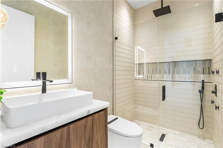 A hallway guest bathroom offers added convenience and privacy for visitors, making it easily accessible without intruding on the main living spaces.