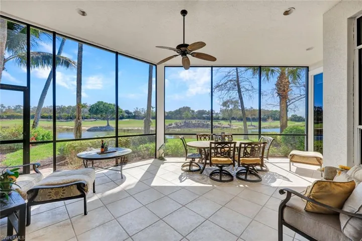 Sunroom with floor to ceiling windows, a water view, tile patterned flooring, plenty of natural light, and golf course view