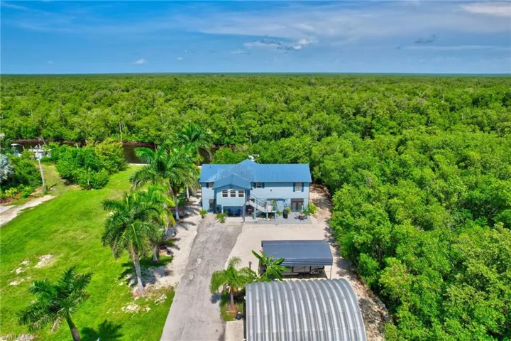 View of front of subject property featuring a heavily wooded area