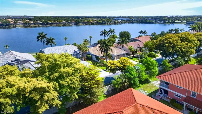Waterfront properties featuring mature landscaping and varied architectural styles