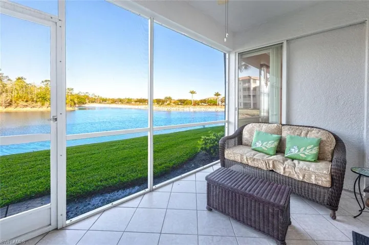 Sunroom / solarium featuring a wealth of natural light and a water view