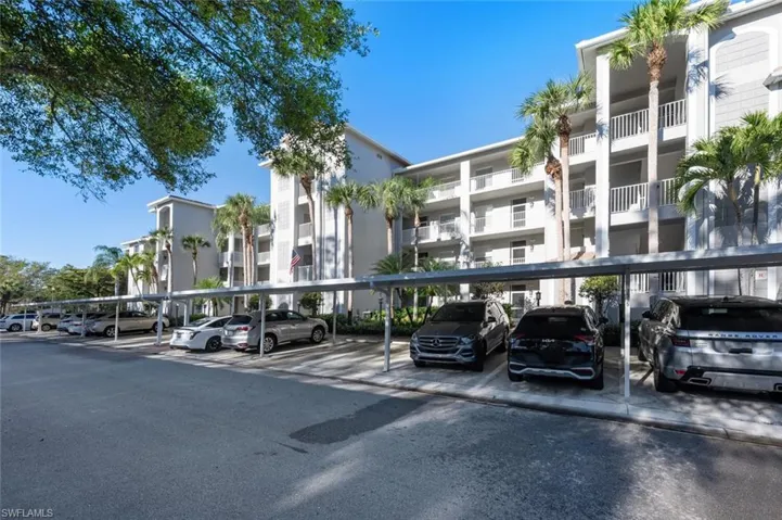 View of property featuring covered parking